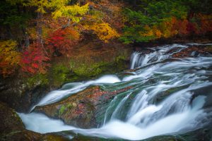 Horizontal shot of Autumn at Ryuzu waterfall and canal from Nikko Japan