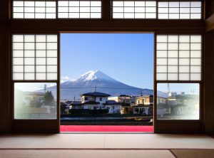 Traditional Japanese indoor house and paper sliding doors and tatami mat open to View of a beautiful Fuji mountain and japanese house in autumn season. Kawaguchiko, Yamanashi, Japan