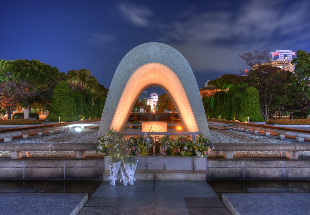 Cenotaph through which the Atomic Dome can be seen at at Peace Memorial Park in Hiroshima