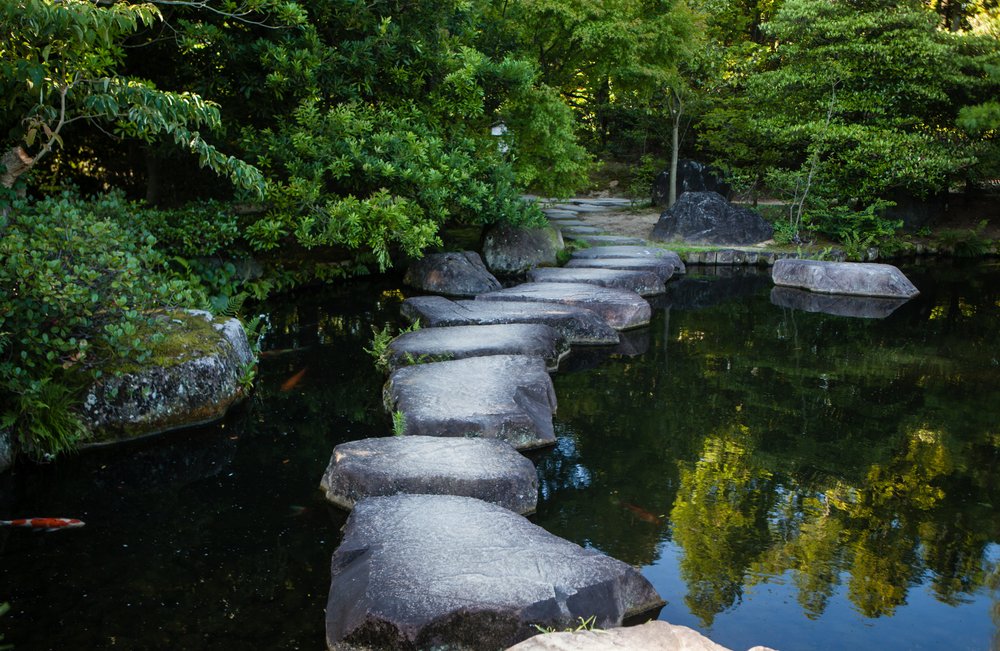 Step stones path over a pond in Koko-en Garden near White Egret Castle, in Himeji, Hyogo Prefecture in Japan