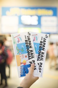 Passenger showing JR Japan Rail Pass Exchange Order Voucher at JR Ticket office