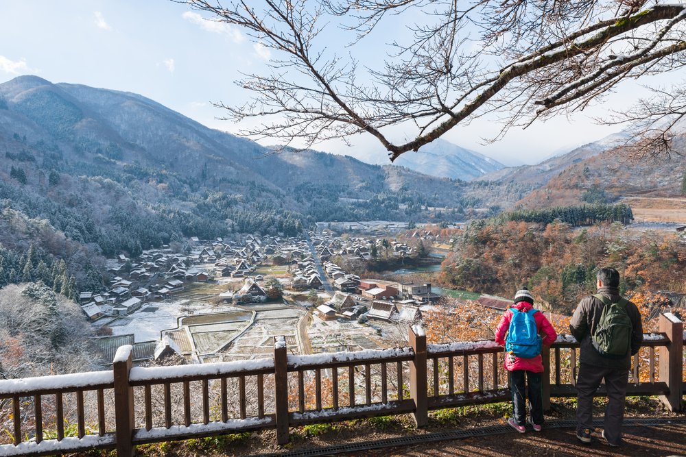 Tourist looking Japanese village from Shirakawago Shiroyama Observatory Deck