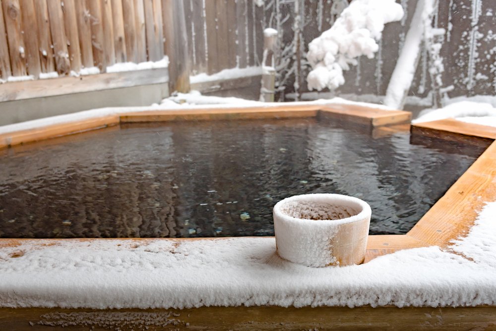 hot spring called onsen cover by snow in Japanese ryokan on the moutain okuhida takayama