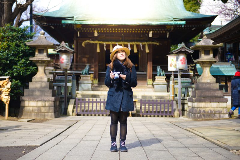 sian woman photographer is enjoy traveling into Ueno Park in Tokyo